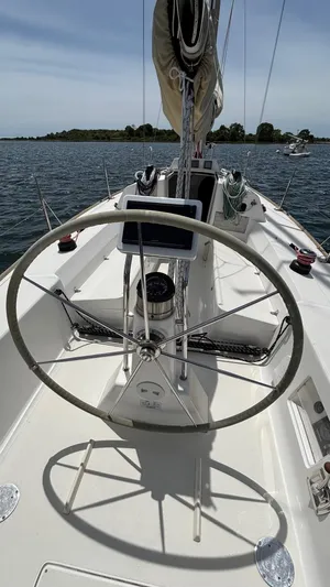 Seabird Yacht Photos Pics 2012 J Boats J/95 sailboat cockpit with steering wheel on calm water.