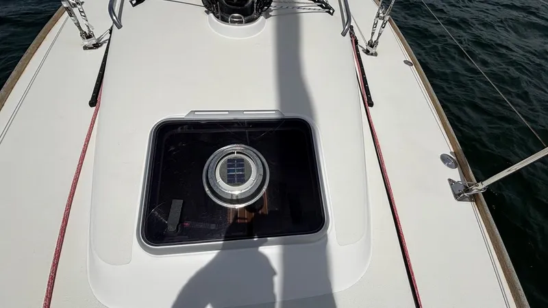 Seabird Yacht Photos Pics 2012 J Boats J/95 deck with hatch, shadow, and water in background.