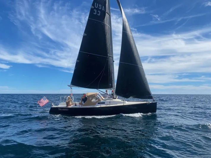 Seabird Yacht Photos Pics Sailing yacht J Boats J/95 2012 on open sea with American flag.