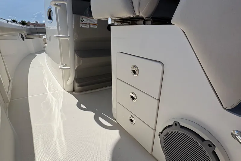  Yacht Photos Pics 2017 Boston Whaler 330 Outrage interior with storage drawers and speaker detail.