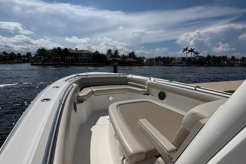  Yacht Photos Pics 2017 Boston Whaler 330 Outrage boat interior with waterfront view, under a partly cloudy sky.