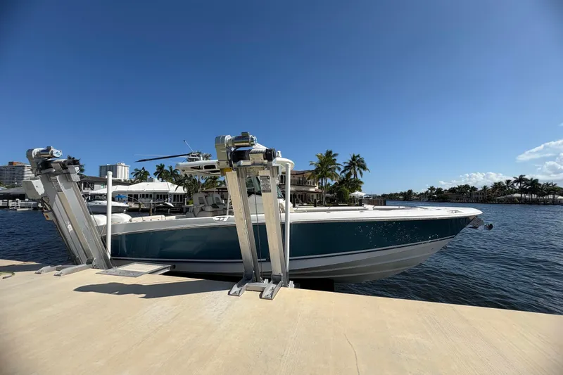  Yacht Photos Pics 2017 Boston Whaler 330 Outrage docked by waterfront, clear blue sky.