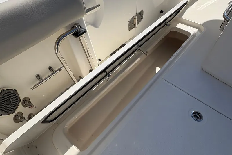  Yacht Photos Pics 2017 Boston Whaler 330 Outrage storage compartment with open lid and stainless steel fixtures.