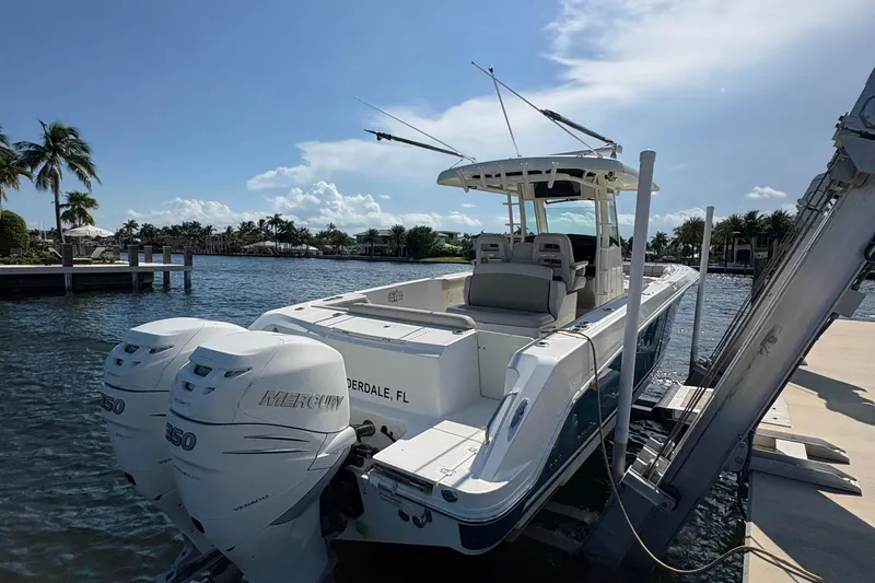  Yacht Photos Pics 2017 Boston Whaler 330 Outrage docked, featuring twin Mercury engines, under a sunny sky.
