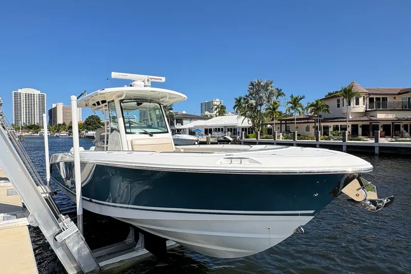  Yacht Photos Pics 2017 Boston Whaler 330 Outrage boat docked near waterfront homes and city skyline.