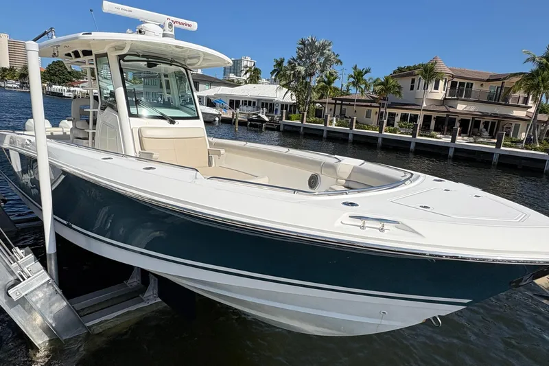  Yacht Photos Pics 2017 Boston Whaler 330 Outrage boat docked by waterfront homes.