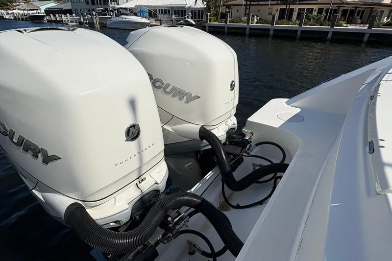 Yacht Photos Pics 2017 Boston Whaler 330 Outrage with twin Mercury outboard engines docked by waterfront homes.