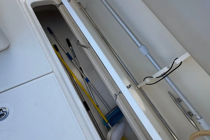  Yacht Photos Pics Storage compartment on a 2017 Boston Whaler 330 Outrage boat with cleaning tools.