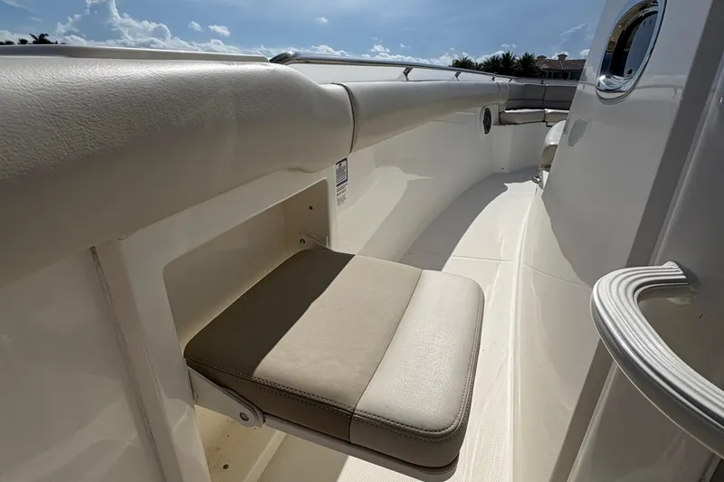  Yacht Photos Pics 2017 Boston Whaler 330 Outrage boat interior with foldable seat and sleek design.