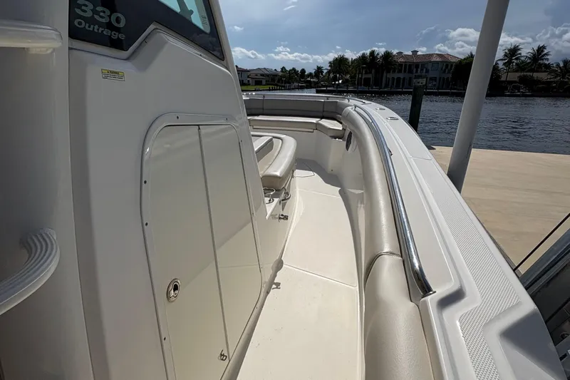  Yacht Photos Pics 2017 Boston Whaler 330 Outrage boat, sleek design, docked by waterfront homes.