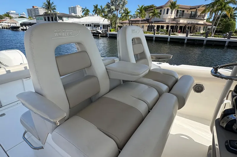  Yacht Photos Pics Luxury seating on a 2017 Boston Whaler 330 Outrage boat, docked by waterfront homes.