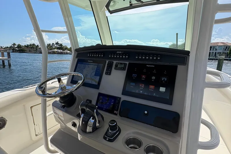  Yacht Photos Pics 2017 Boston Whaler 330 Outrage helm with advanced navigation displays and controls.