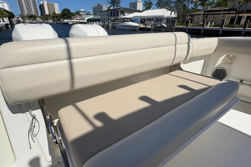  Yacht Photos Pics 2017 Boston Whaler 330 Outrage boat seat with waterfront view and cityscape background.