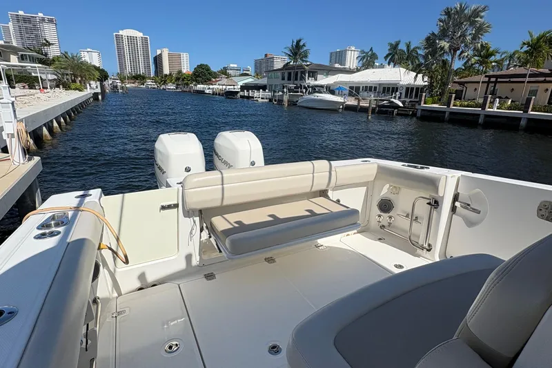  Yacht Photos Pics 2017 Boston Whaler 330 Outrage boat docked in a scenic waterfront location.