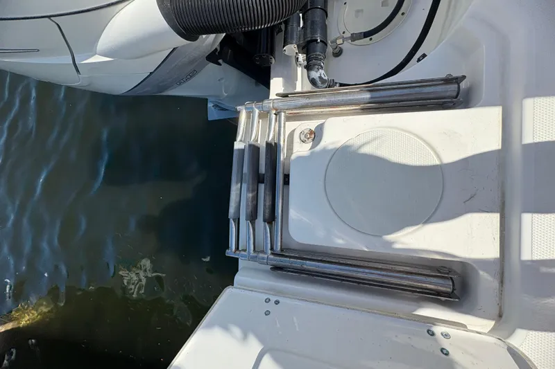  Yacht Photos Pics 2017 Boston Whaler 330 Outrage swim platform with retractable ladder and water view.