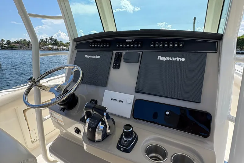  Yacht Photos Pics 2017 Boston Whaler 330 Outrage helm with Raymarine electronics and steering wheel.