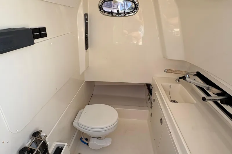  Yacht Photos Pics Interior of 2017 Boston Whaler 330 Outrage boat bathroom with toilet and sink.