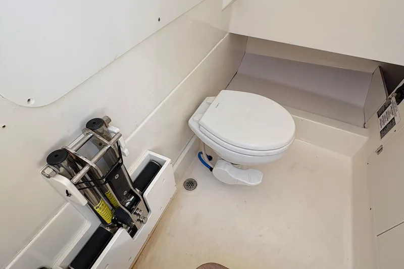  Yacht Photos Pics Boston Whaler 330 Outrage 2017 boat interior with toilet and storage compartment.