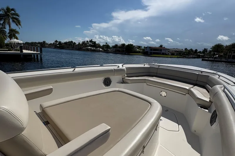  Yacht Photos Pics 2017 Boston Whaler 330 Outrage boat interior with cushioned seating, dockside view.