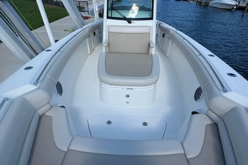  Yacht Photos Pics 2017 Boston Whaler 330 Outrage boat interior with cushioned seating and sleek design.