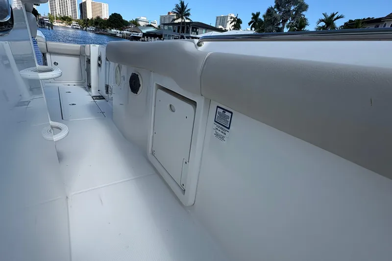  Yacht Photos Pics 2017 Boston Whaler 330 Outrage boat interior with storage compartments and waterfront view.