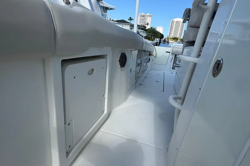  Yacht Photos Pics 2017 Boston Whaler 330 Outrage interior, showcasing sleek white seating and storage compartments.