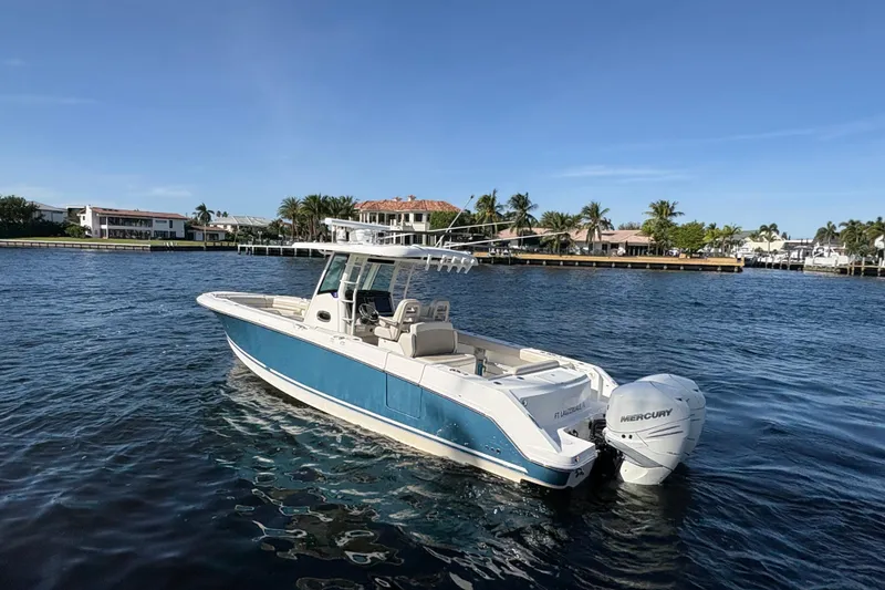  Yacht Photos Pics 2017 Boston Whaler 330 Outrage boat on water, with Mercury engines, near waterfront homes.
