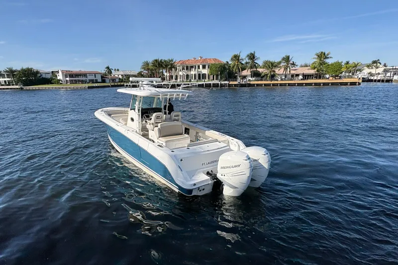  Yacht Photos Pics 2017 Boston Whaler 330 Outrage boat on water, featuring twin Mercury engines.