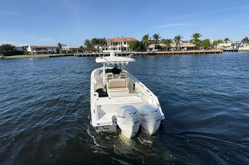  Yacht Photos Pics 2017 Boston Whaler 330 Outrage boat cruising on a sunny waterfront.