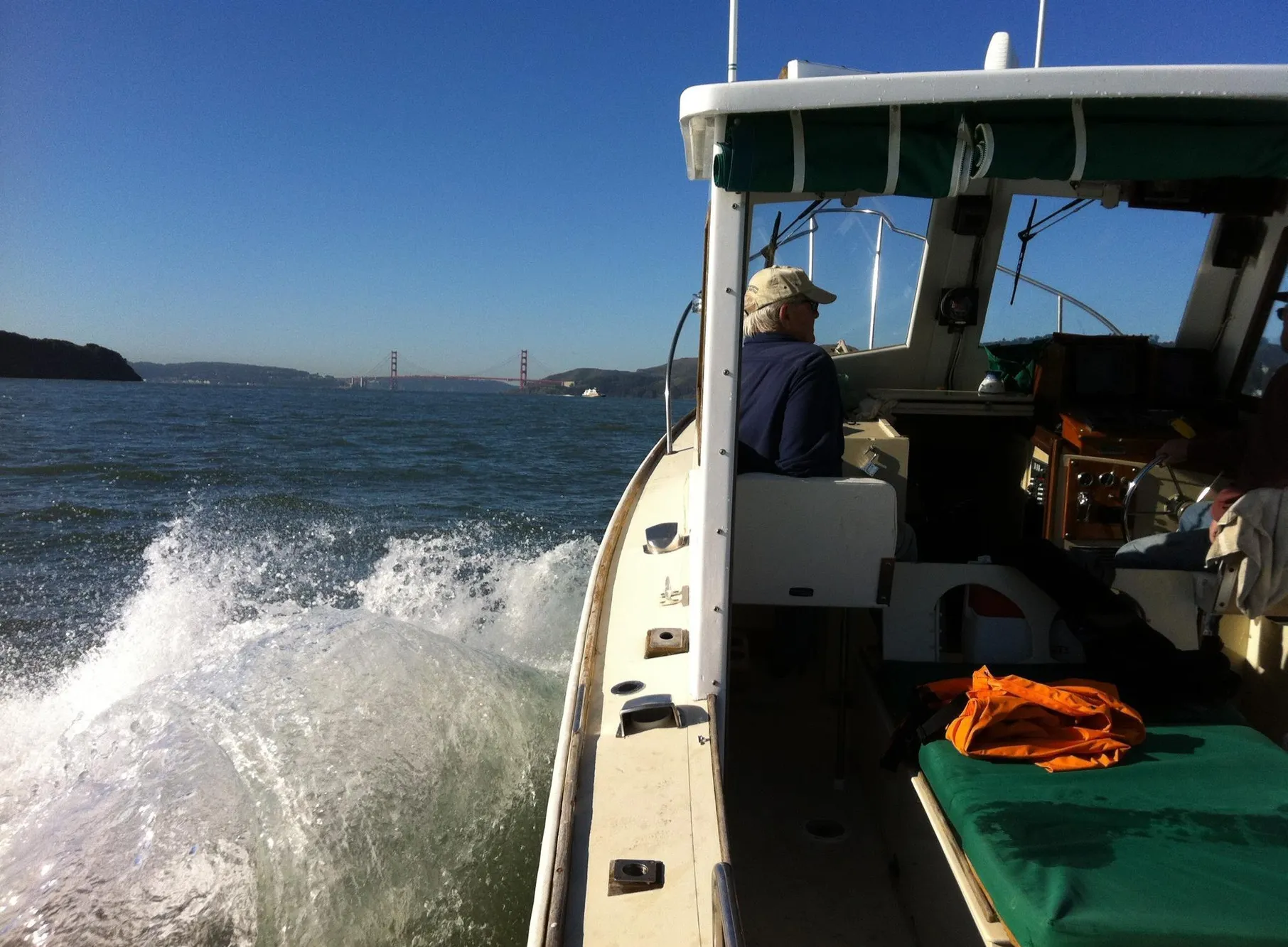 1974 Dyer 29' Sport Fisher cruising on open water with bridge in background.