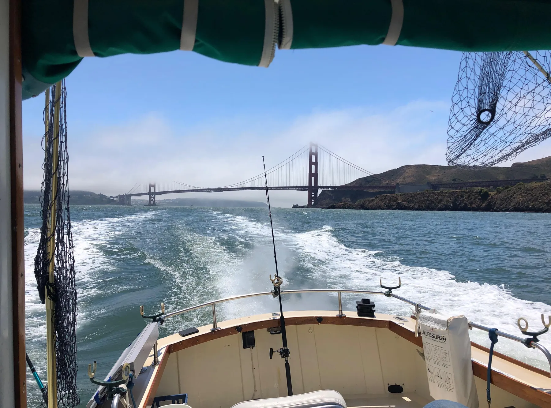 1974 Dyer 29' Sport Fisher cruising near Golden Gate Bridge, scenic view.