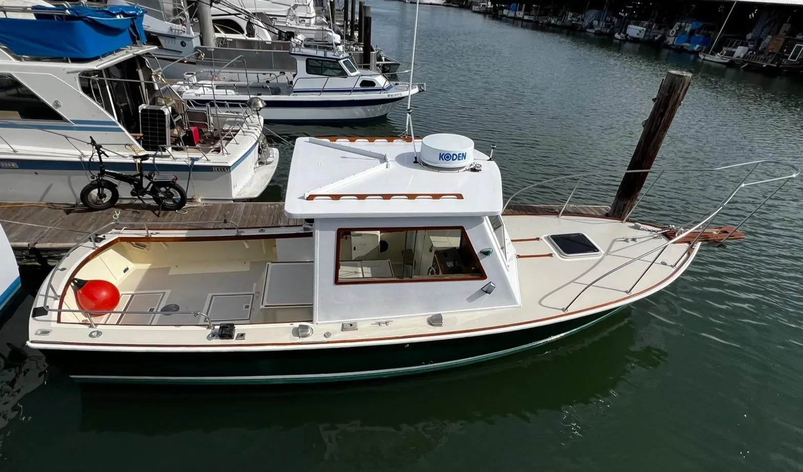 1974 Dyer 29' Sport Fisher boat docked in marina, side view.