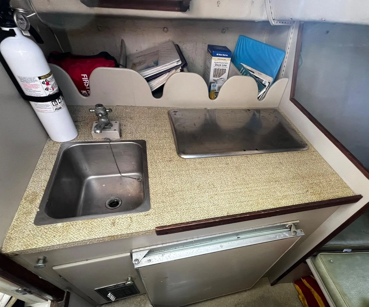 1974 Dyer 29' Sport Fisher galley with sink, countertop, and storage.