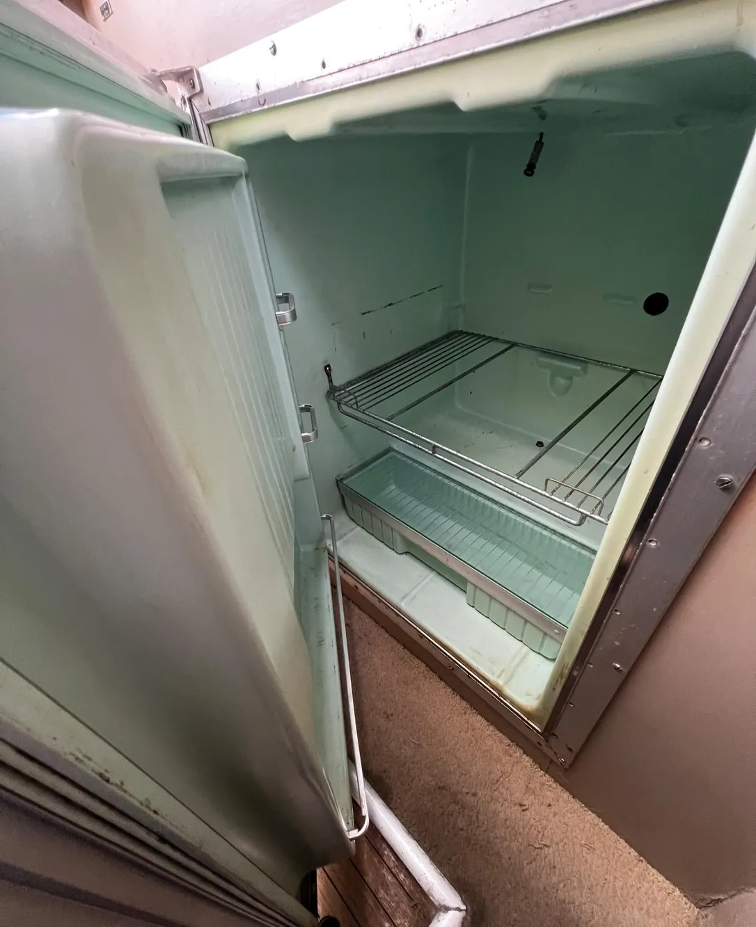 Open refrigerator inside a 1974 Dyer 29' Sport Fisher boat.