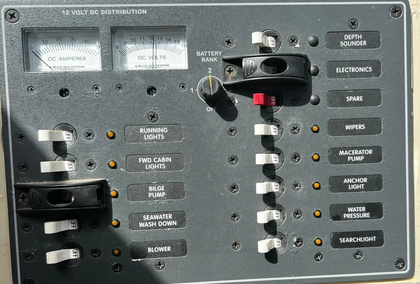 Control panel of a 1974 Dyer 29' Sport Fisher boat with various switches and gauges.