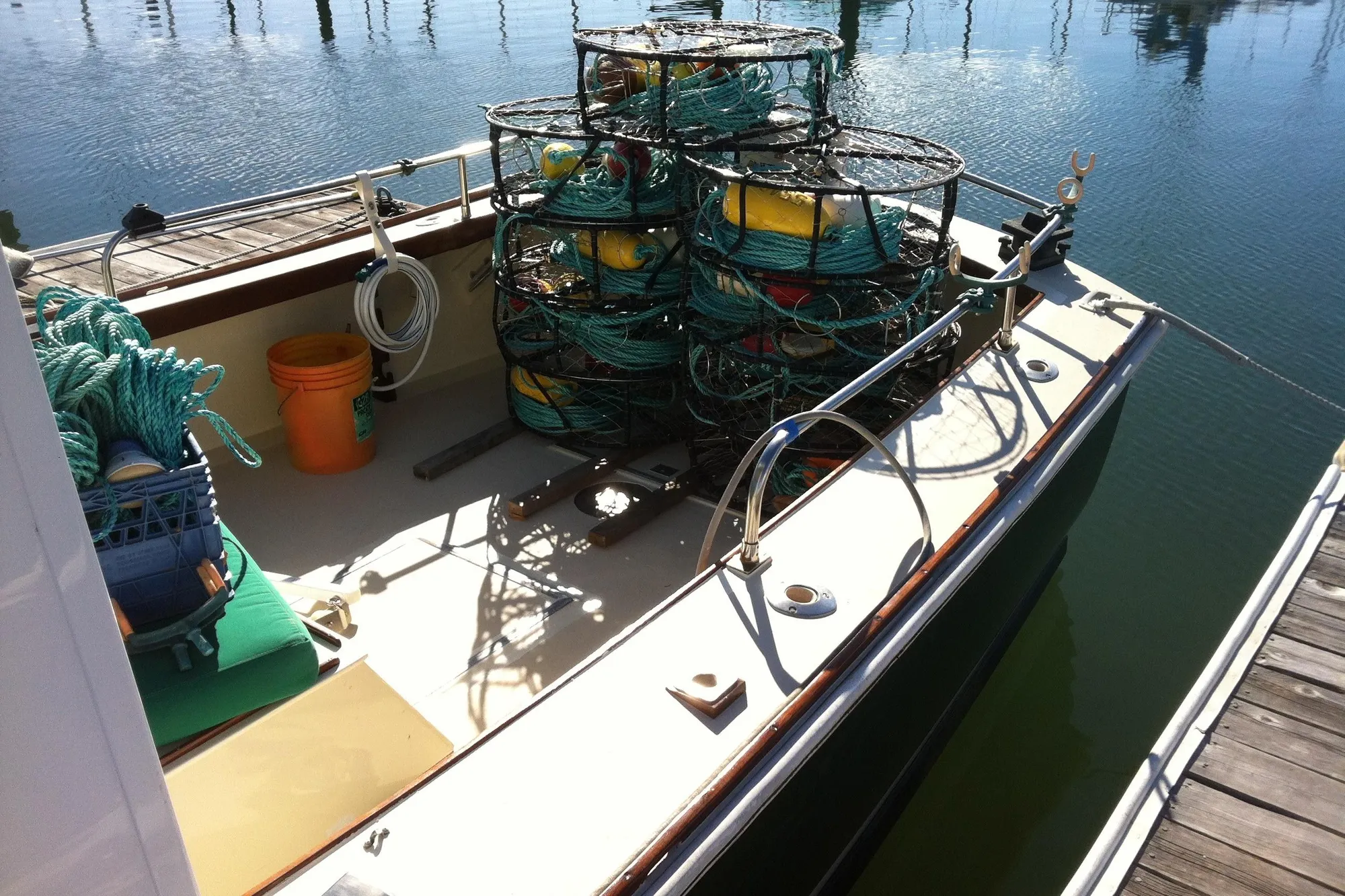 1974 Dyer 29' Sport Fisher boat with fishing gear and traps on deck.