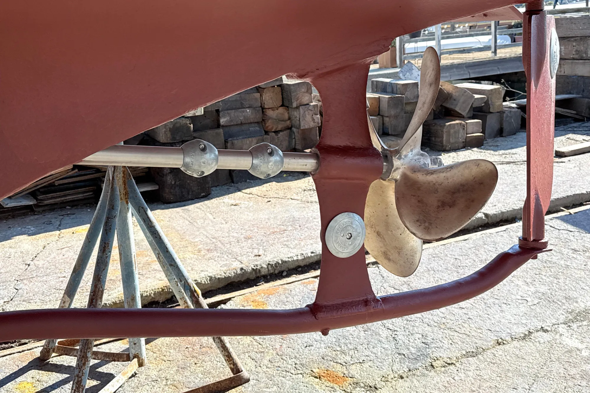 Propeller and shaft of a 1974 Dyer 29' Sport Fisher boat on dry dock.