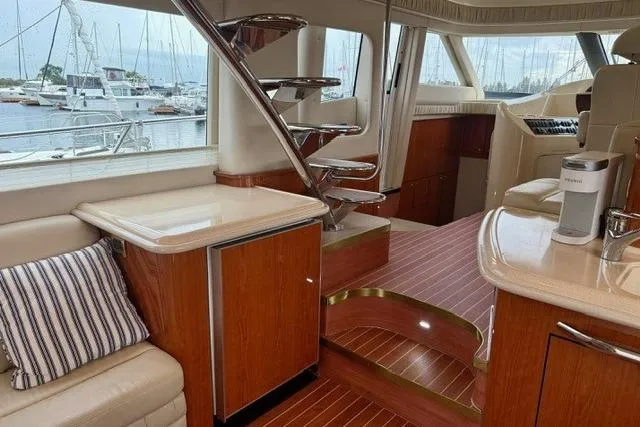  Yacht Photos Pics Luxurious interior of 2001 Sea Ray 540 Cockpit Motor Yacht with elegant wood finishes.