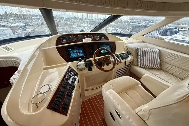  Yacht Photos Pics Luxurious helm of 2001 Sea Ray 540 Cockpit Motor Yacht with leather seating and advanced controls.