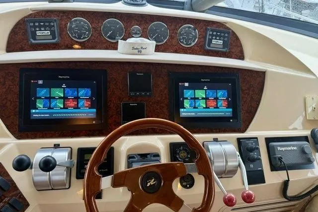  Yacht Photos Pics 2001 Sea Ray 540 Cockpit Motor Yacht dashboard with navigation screens and controls.