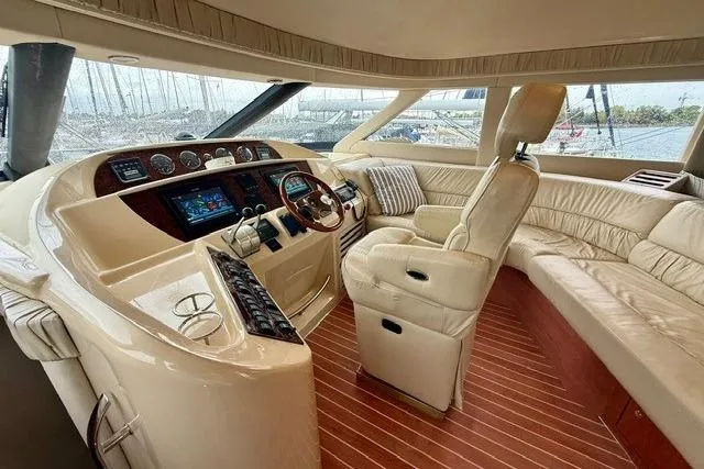  Yacht Photos Pics Luxurious interior of 2001 Sea Ray 540 Cockpit Motor Yacht with plush seating and modern controls.