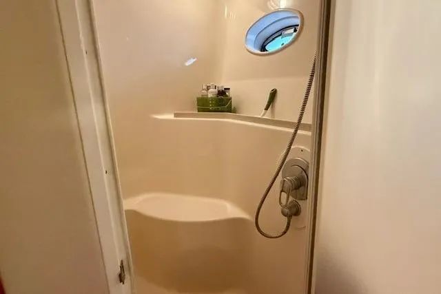  Yacht Photos Pics Bathroom interior of 2001 Sea Ray 540 Cockpit Motor Yacht with shower and porthole.