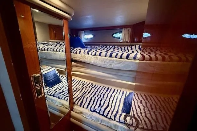  Yacht Photos Pics Interior of 2001 Sea Ray 540 Cockpit Motor Yacht with striped bedding and porthole windows.