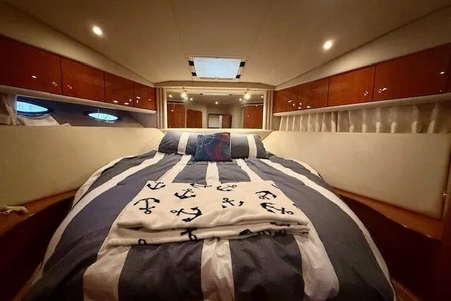  Yacht Photos Pics Luxurious 2001 Sea Ray 540 yacht bedroom with nautical-themed bedding and elegant wood cabinetry.
