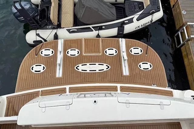  Yacht Photos Pics 2001 Sea Ray 540 Cockpit Motor Yacht with wooden deck and adjacent inflatable boat.