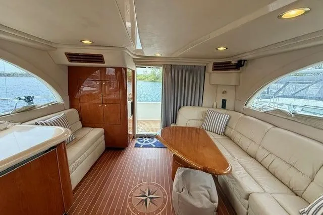  Yacht Photos Pics Luxurious interior of 2001 Sea Ray 540 Cockpit Motor Yacht with elegant seating and wood finishes.