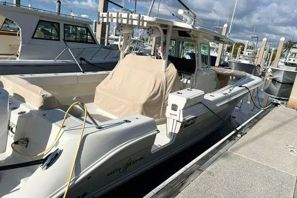 Gyn Tonic Yacht Photos Pics 2018 Hydra-Sports 3000 CC boat docked at marina under cloudy sky.