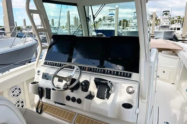 Gyn Tonic Yacht Photos Pics 2018 Hydra-Sports 3000 CC boat dashboard with modern controls and steering wheel.