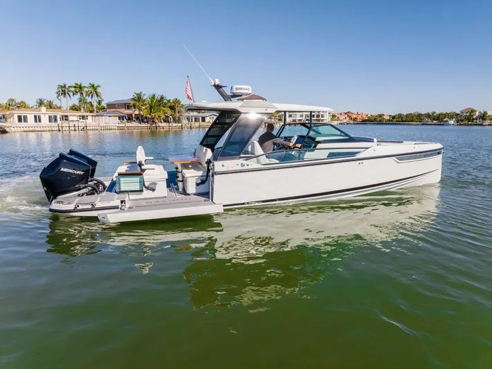  Yacht Photos Pics 2024 Saxdor 320 GTO boat cruising on a sunny day, featuring sleek design and powerful Mercury engine.