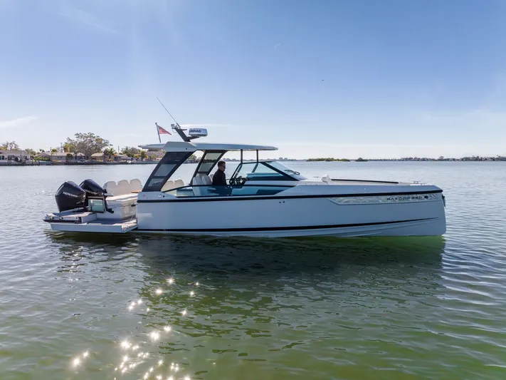  Yacht Photos Pics 2024 Saxdor 320 GTO boat cruising on calm water under clear blue sky.